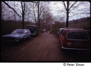 Cars parked along a dirt road, Tree Frog Farm commune