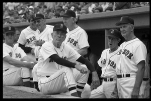 Members of the Red Sox 1946 pennant-winning team await their introductions in the dugout