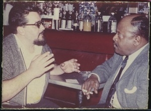 Ben Webster (right) talking with unidentified man at a bar at the Jazz Workshop