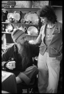 Unidentified man, seated with coffee mug, talking with Nina Keller, Montague Farm commune