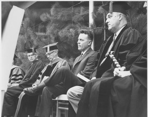 Unidentified man, Provost Gilbert Woodside, Prof. William Ross, and an unidentified man on the stage at the Centennial Convocation