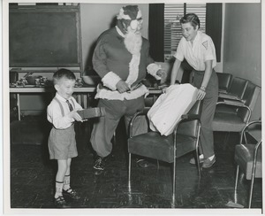 Santa Claus gifting gifts to patient