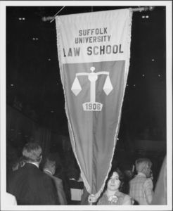 Student holding a Suffolk Law School banner at the 1980 Suffolk University Law School commencement