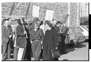 Two nuns walk past DUP Democratic Unionist Party protestors and other shots. Ecumenical service in Downpatrick