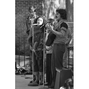 Musical group, consisting of two men and two women, performs at a Latino street festival