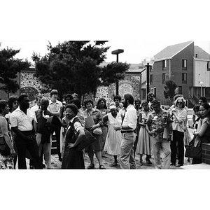 Jorge Hernandez talks to about two dozen people who seem to have gathered for a tour of Villa Victoria.