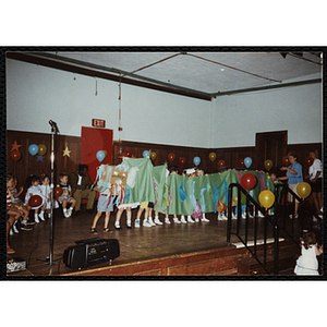 Children perform on a stage