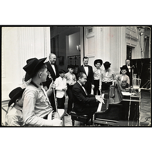President Nixon plays piano in the White House as a group of Bunker Hillbillies and Hillbilly director, Bob 'Ranch Boss' Munstedt, and two other men look on