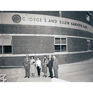 George and Ellen Kariotis stand with President Kenneth Ryder and others outside of Kariotis Hall at the dedication ceremony