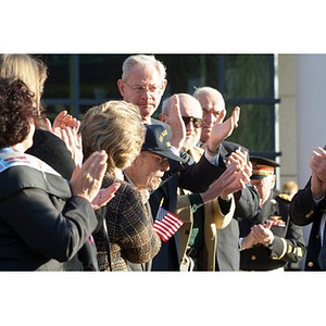 The audience applauds at the Veterans Memorial dedication ceremony