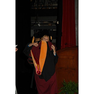 Carol Glod, a professor, and Dean Carole Kenner from the School of Nursing hug during convocation