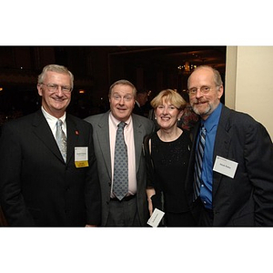 Joseph Fleming (far left) and Mark Hahn (far right) pose with guests at the Alumni Ball