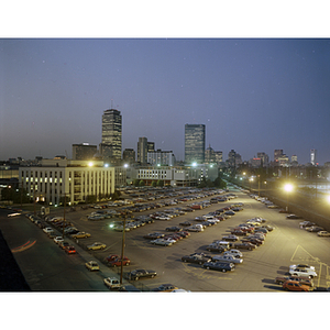 A view of Northeastern's main campus at night with the Boston skyline in the background