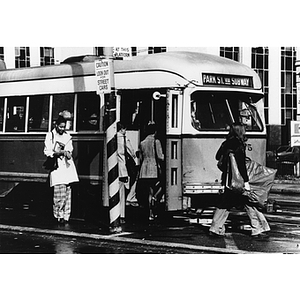 Students boarding the green line trolley on Huntington Avenue on Northeastern University's campus
