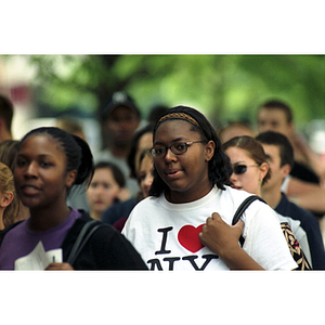 An African American woman walking with a group of students