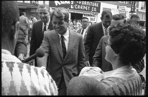 Robert F. Kennedy shaking hands in the street in Worthington, Minn., during the Turkey Day festivities