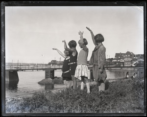 Children waving by the shore