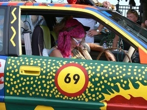 Parade marchers in brightly decorated car : Provincetown Carnival parade