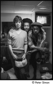 Mick Jagger, unidentified man, and Peter Tosh (l. to r.) backstage on Saturday Night Live: three-quarter length portrait