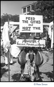 Sign at a Mobilization for Survival antinuclear demonstration near Draper Laboratory, MIT, reading 'Feed the cities and not the monster of nuclear power and arms'