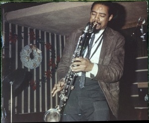 Eric Dolphy: three-quarter length portrait performing on stage
