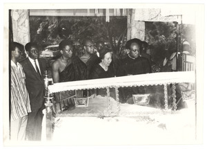 Shirley Graham Du Bois and Kwame Nkrumah look over the open casket at state funeral for W. E. B. Du Bois