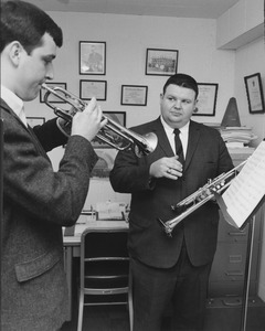 Walter Chesnut holding trumpet, while instructing student also playing trumpet