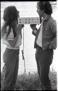 Lacey Mason and Elliot Blinder holding stereo equipment