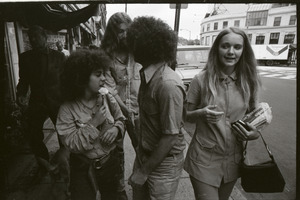 Abbie Hoffman walking in Harvard Square, talking with young woman (Church of the Final Judgment)