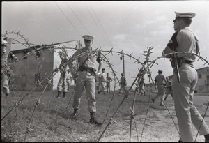 Antiwar demonstration at Fort Dix, N.J.: view of military police through barbed wire