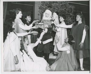 Man dressed as Santa Claus with performers