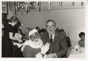 Dr. Folsom on Santa's lap at Christmas party