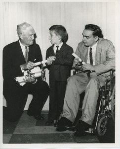 Bruce Barton handing diplomas to young clients at graduation exercises