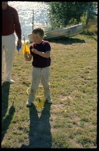 Boy playing with lawn darts at the picnic, Pine Beach