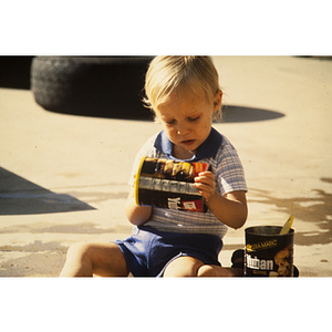 Child holding coffee tin