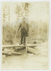 Booker T. Washington on log bridge