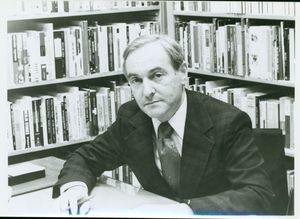 Suffolk University Professor Stanley M. Vogel (CAS) - Department Chair - English, seated with bookshelf in background