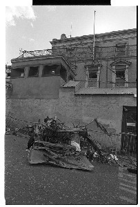 Car bomb at RUC station, Downpatrick. Shots of remains of car and of children looking at the remains of the car