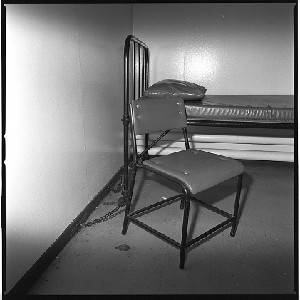 RUC station, Castlereagh, Belfast. Notorious for being the place in which many IRA prisoners were interrogated.  Known commonly as the Castlereagh Holding Centre. Bobbie was the only photographer allowed into the building to take photographs before it was demolished. Cell with bed and chair chained to the wall