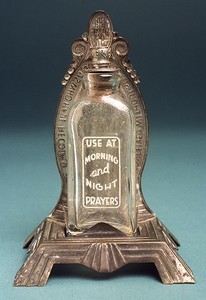 Holy water bottle on Miraculous Medal stand