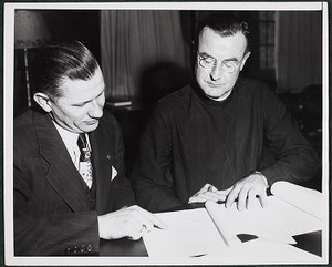 Rev. William Keleher and John Volpe signing contract for Philosophy Building