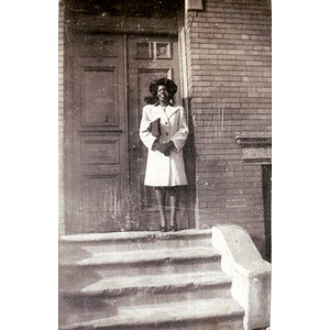 Unidentified woman poses on stairs