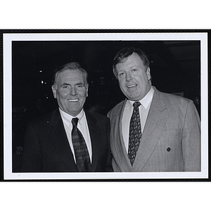 Raymond L. Flynn, former Mayor of Boston, standing at left, posing with an unidentified man at a St. Patrick's Day Luncheon