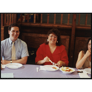 A man and two women eat at a table at a Boys & Girls Club Awards Night