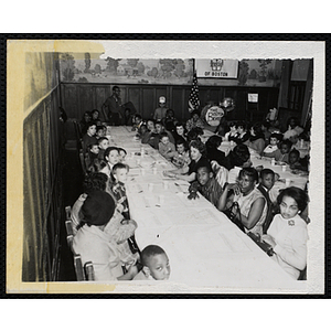 Women and boys sit at long tables during a Mothers' Club banquet
