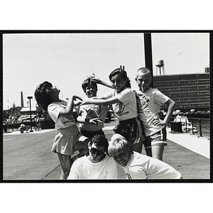 A Group of boys and girls pose with a counselor at the Charlestown Navy Yard