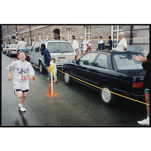 A boy runs in the Battle of Bunker Hill Road Race