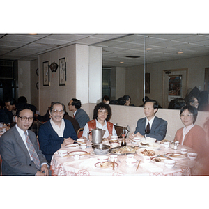 Members of the Chinese Progressive Association sit with members of the Chinese consulate in New York City at a restaurant