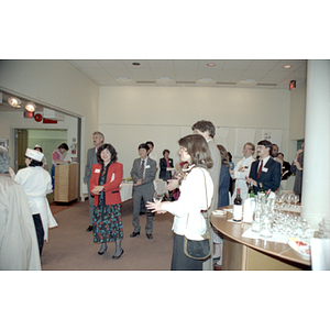 Charlene Tse and other guests listen to a woman speaking at an food tasting event