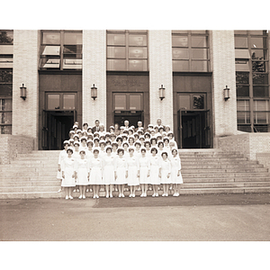 Participants of the capping ceremony for Assistant Nurses standing on the steps of the Ell Student Center